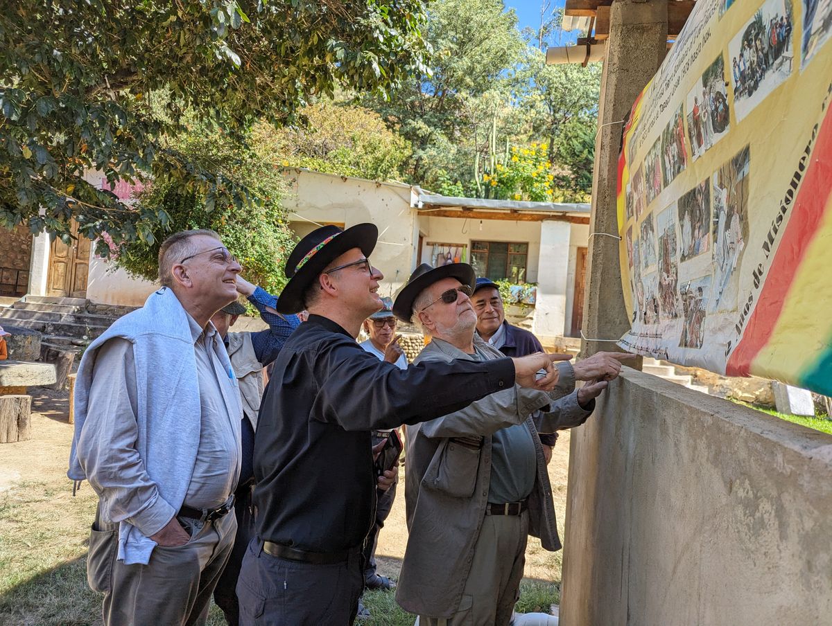 Alejo Gerling zeigt den Gästen Plakate, die er zu Jubiläen geschenkt bekommen hat. Mit im Bild Bischof Dr. Franz Jung und Pfarrer Thomas Hermes.