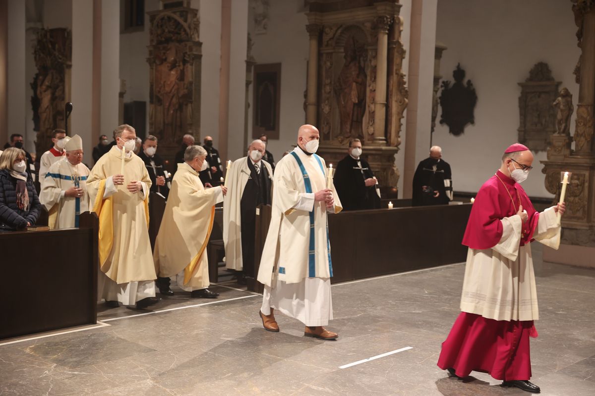 Mit brennenden Kerzen in Händen zogen der Weihbischof und das Domkapitel vom Menoraleuchter zum Altar. Mit brennenden Kerzen in Händen zogen der Weihbischof und das Domkapitel vom Menoraleuchter zum Altar.